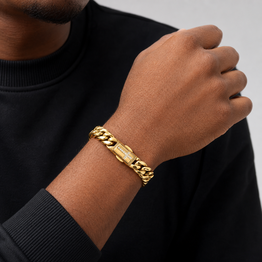 Model wearing gold polished Cuban link bracelet with cross pavé clasp